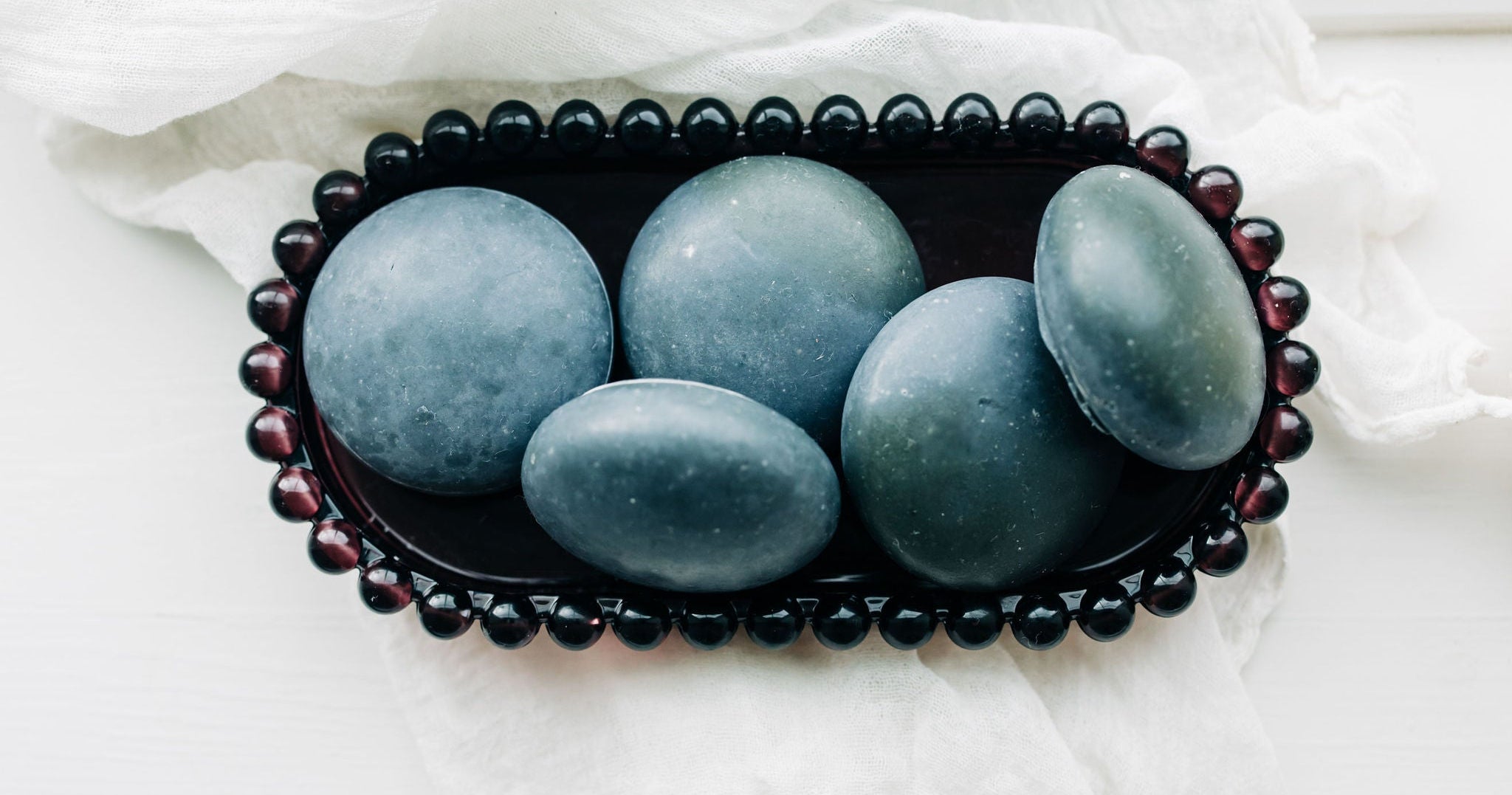 Charcoal Face Stones in Stacked in Soap Dish